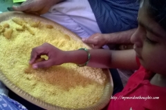 A child writing on rice with turmeric on Vijayadasami