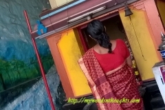 A devotee standing in front of Hanuman